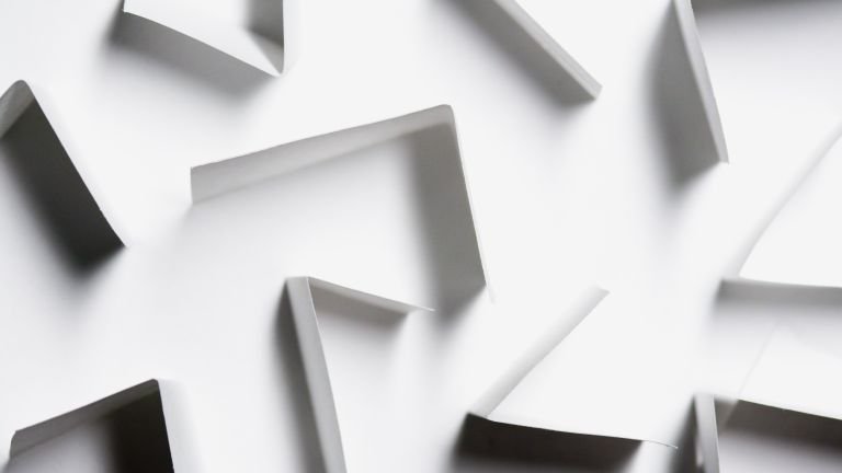 Abstract white paper shapes creating a modern geometric design with shadows.